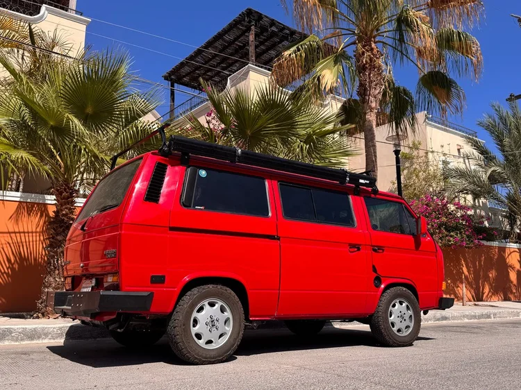 Rear three-quarter view of a red Volkswagen Vanagon