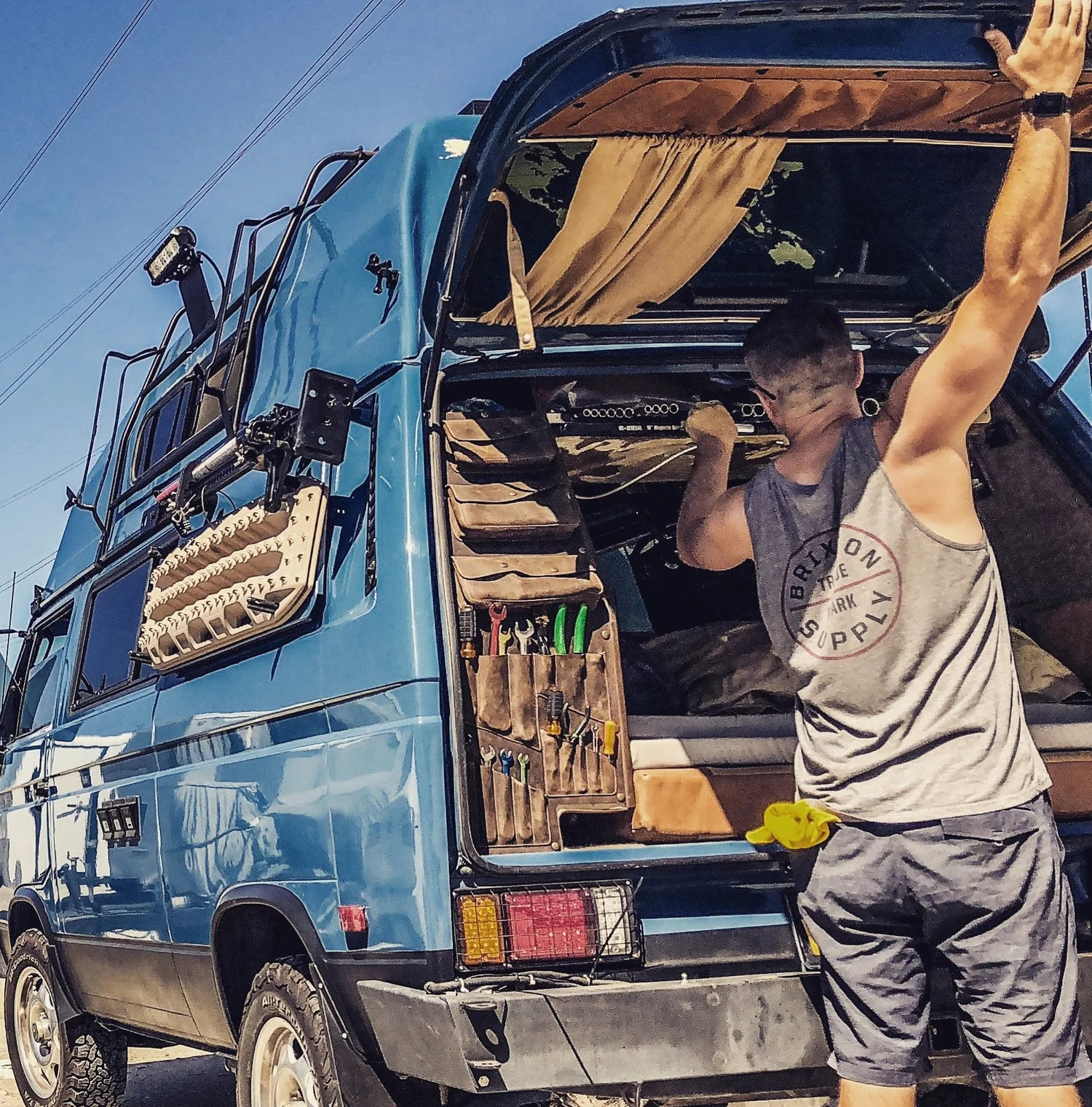 Shane beside his blue Westfalia Penny, with a leather Westy Bravo organizer installed at the rear