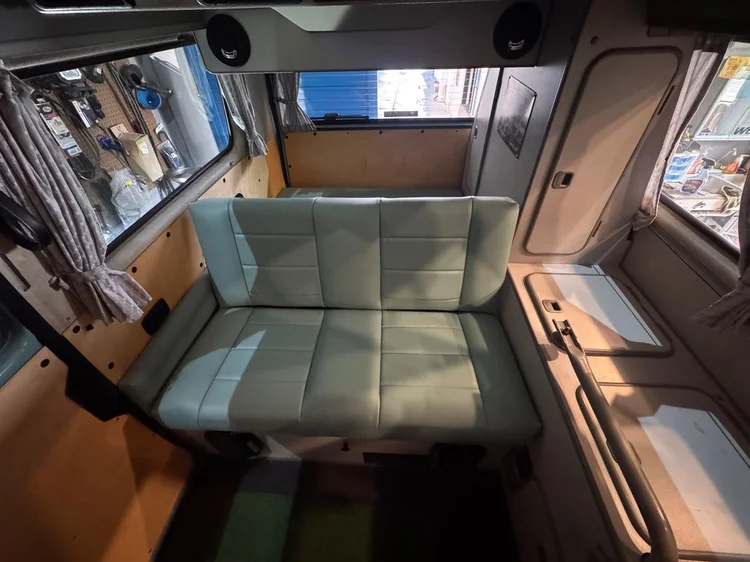 Camper rear bench seat and wooden interior cabinets