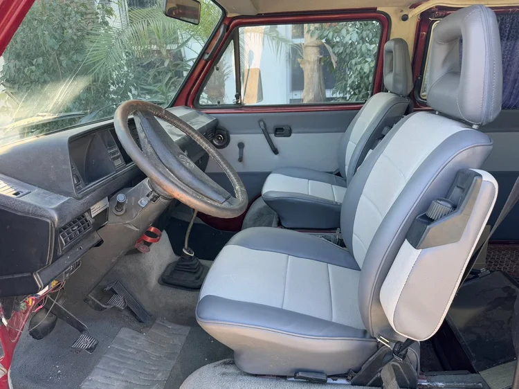 Gray upholstered front seats and dashboard in a Volkswagen van