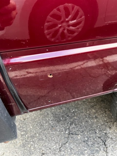 Close-up of a burgundy Volkswagen door and lower panel