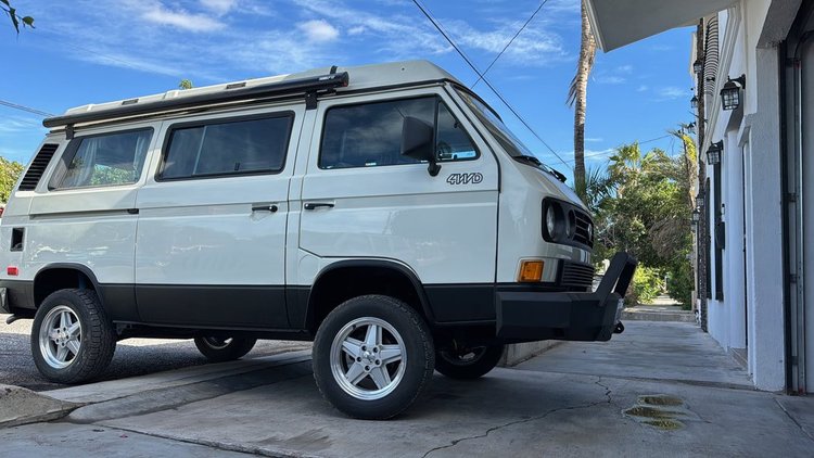White Volkswagen Vanagon with black lower body trim