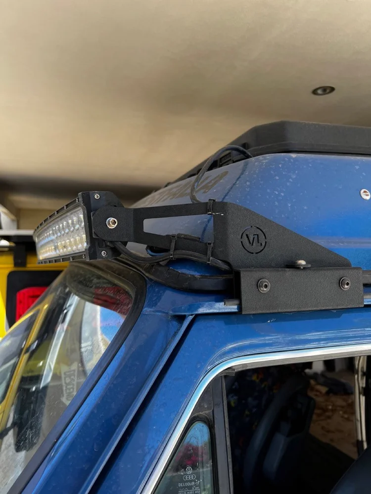 A close-up of an auxiliary light bar and its mounting bracket.