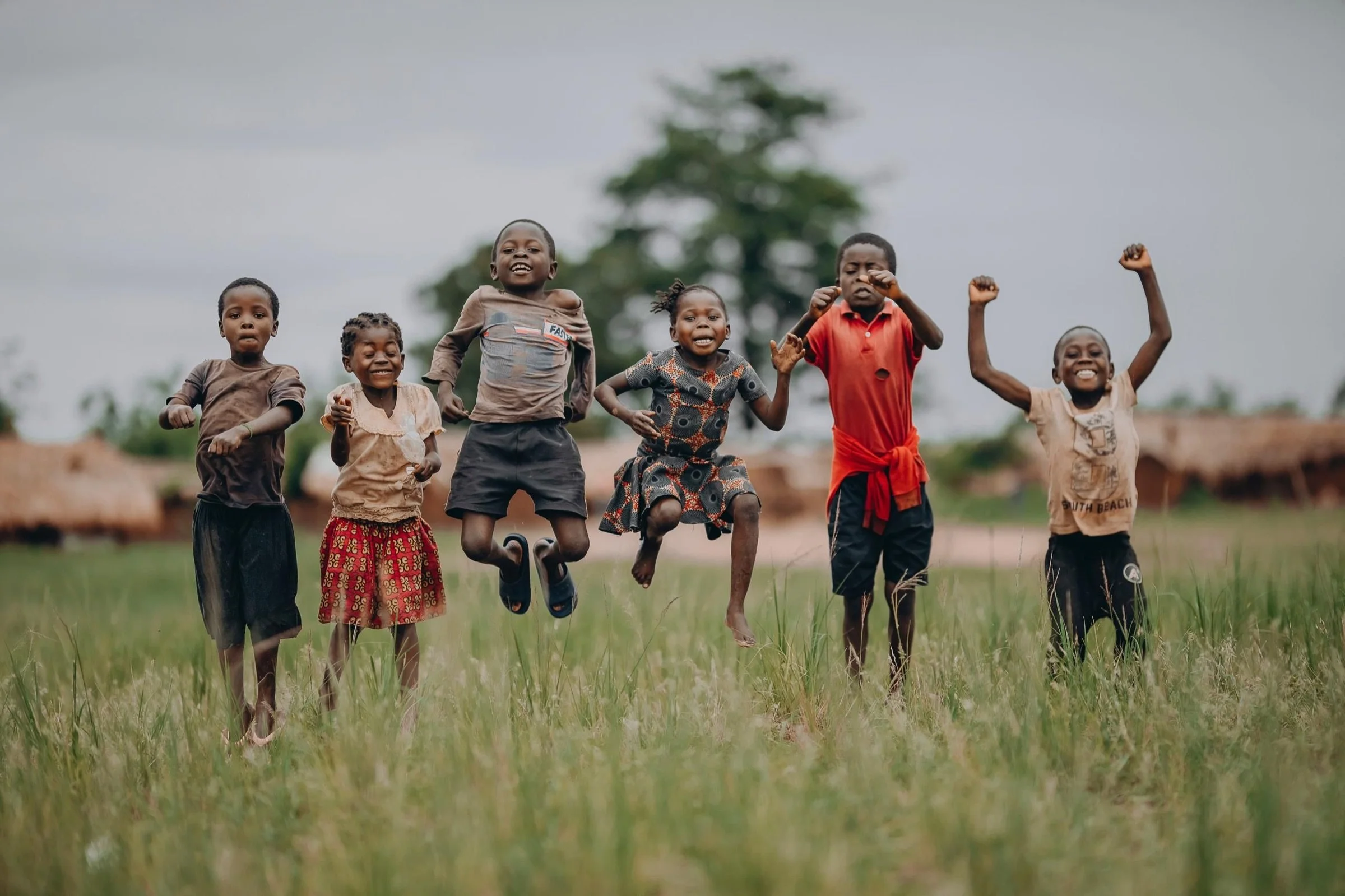 Children jumping and playing together outdoors