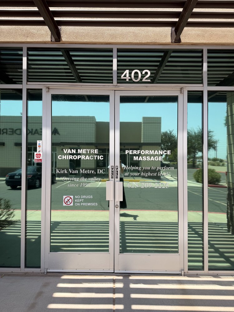 The front entrance to Van Metre Chiropractic, with Suite 402 above the glass doors.