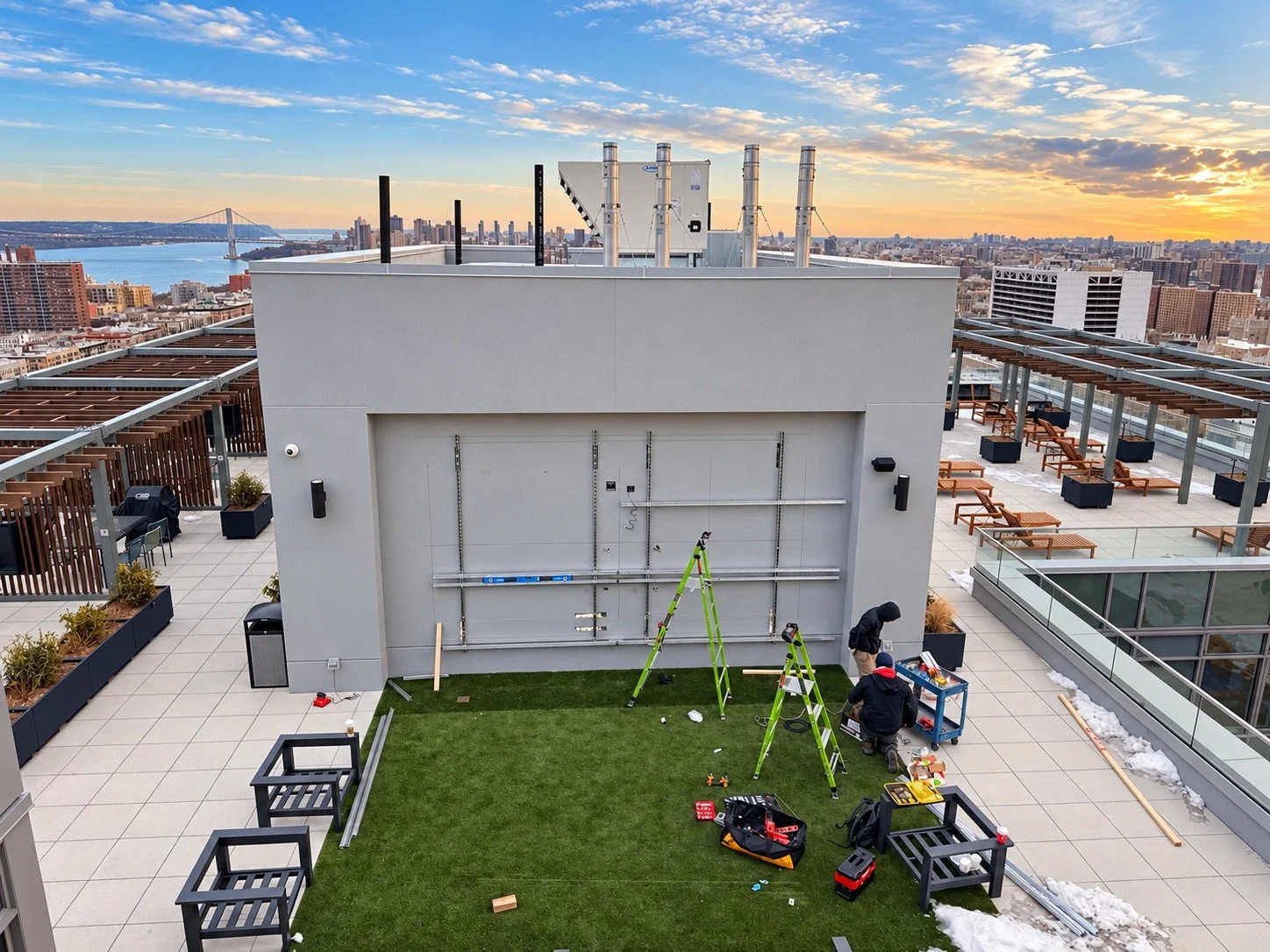 Display mounting framework being installed on the rooftop wall