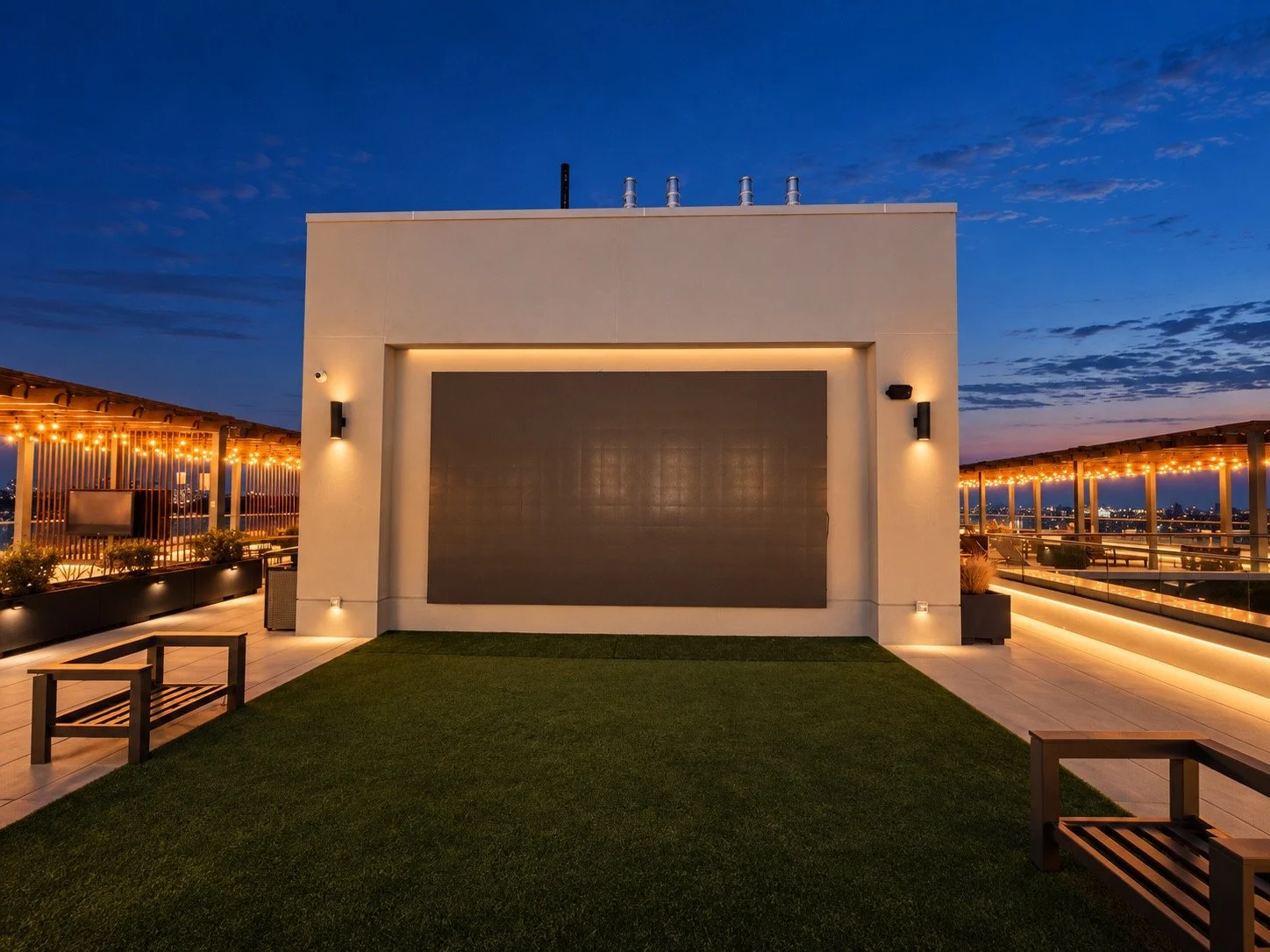 Completed rooftop display area at dusk with the surrounding lighting on