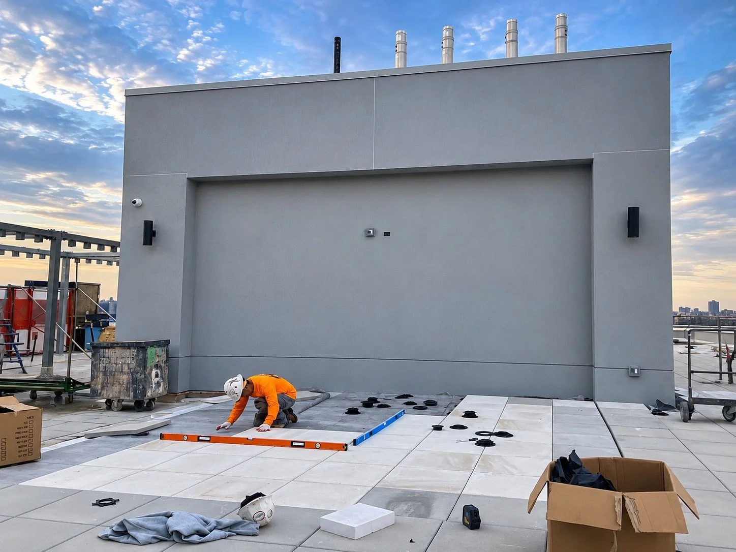 Rooftop wall before the display installation, with floor work underway