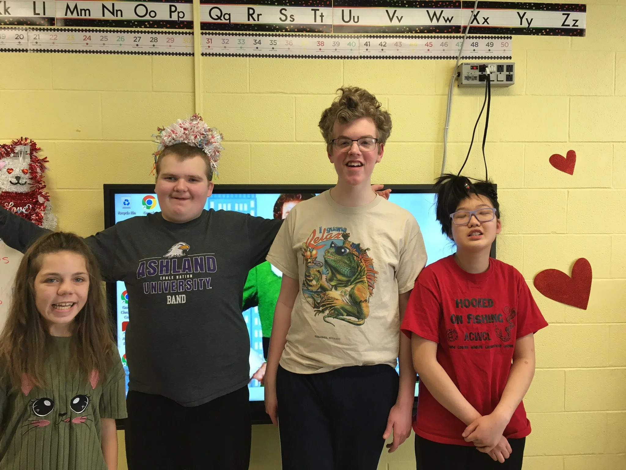 Four Dale-Roy School students laughing and standing together in their classroom — showing the friendship and community at the heart of Dale-Roy.