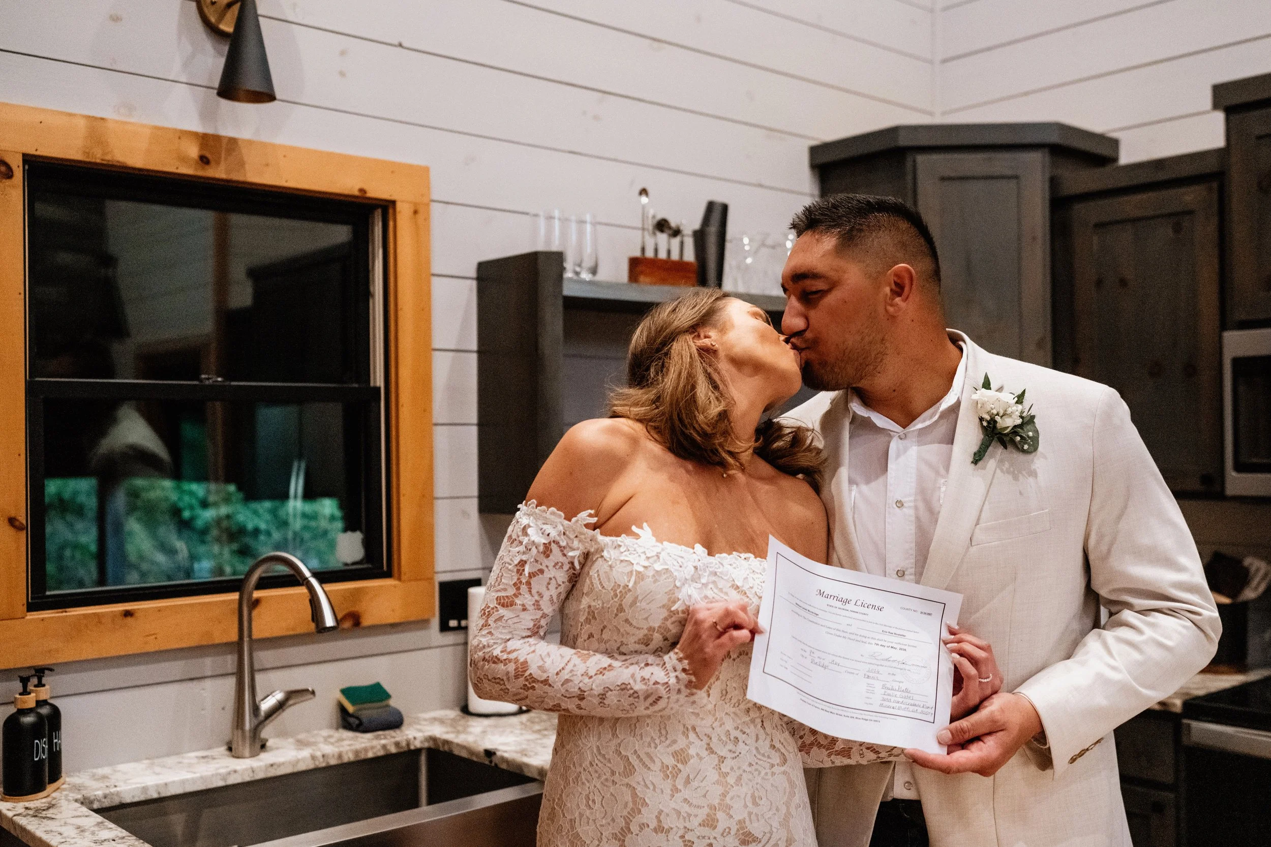 Erin and William sharing a kiss after their wedding ceremony in Blue Ridge, Georgia with officiant Emilie Gate