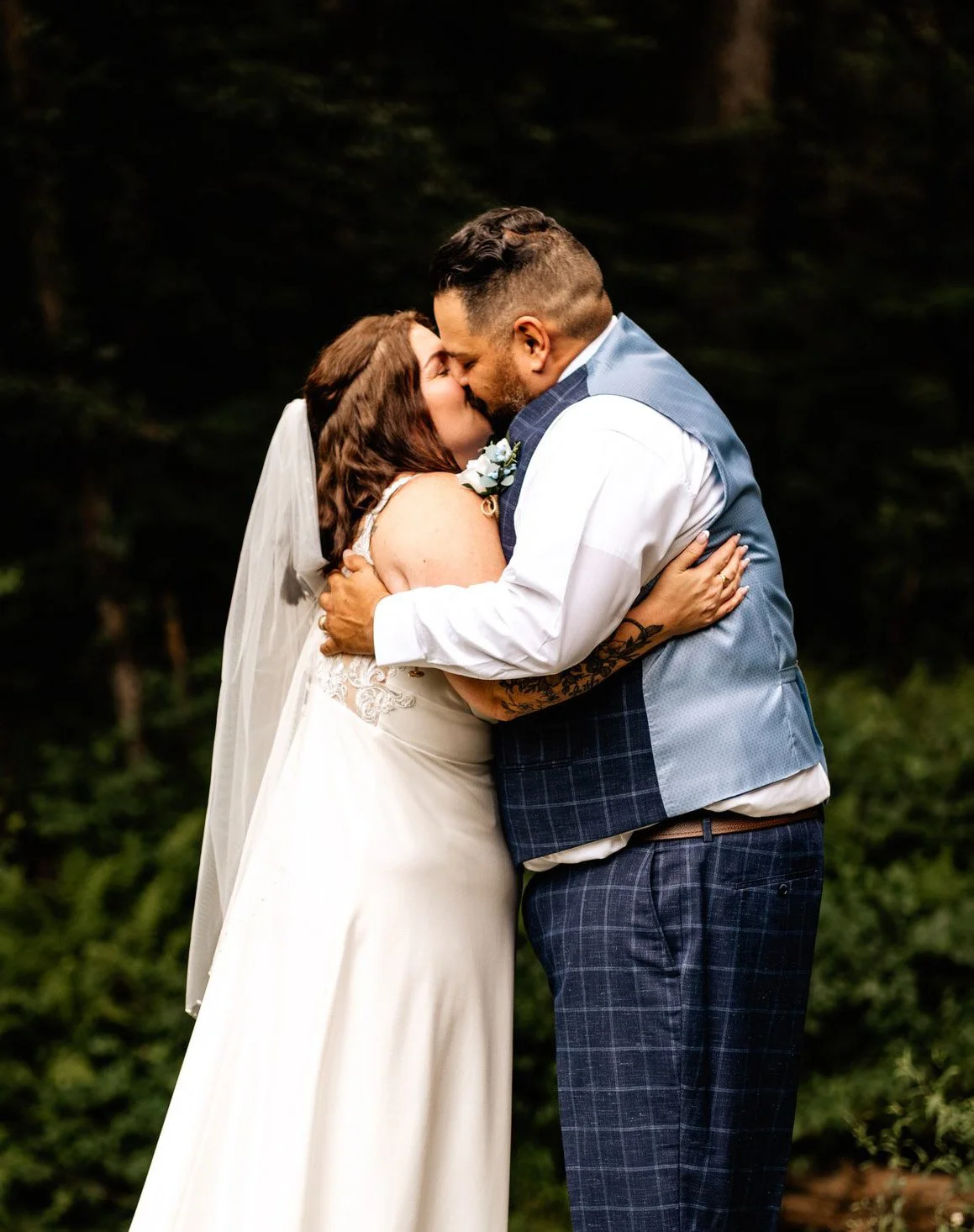 Bride and groom kissing after officiating their mountain wedding ceremony
