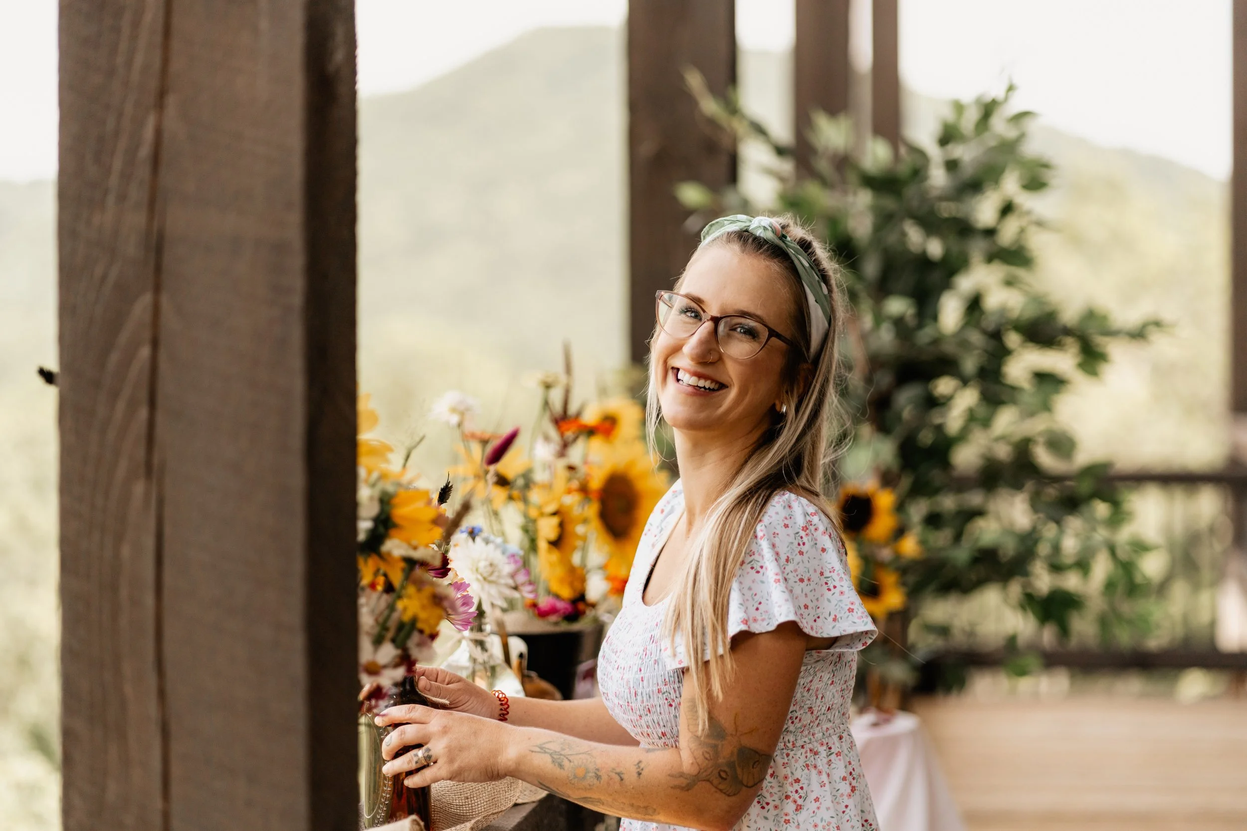 Bride Meredith laughing during her Blue Ridge, Georgia wedding ceremony with officiant Emilie Gates