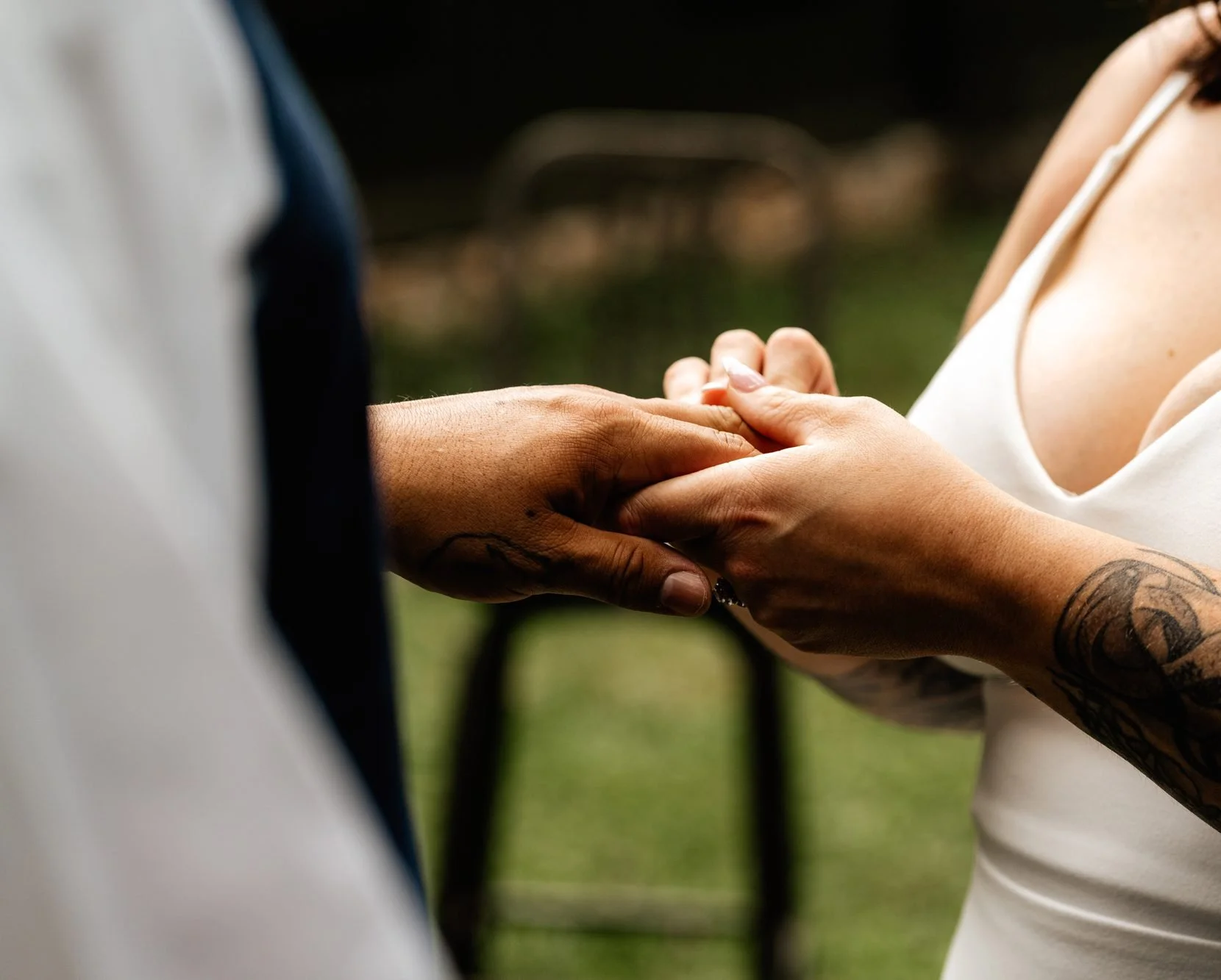 Close up of hands exchanging wedding rings