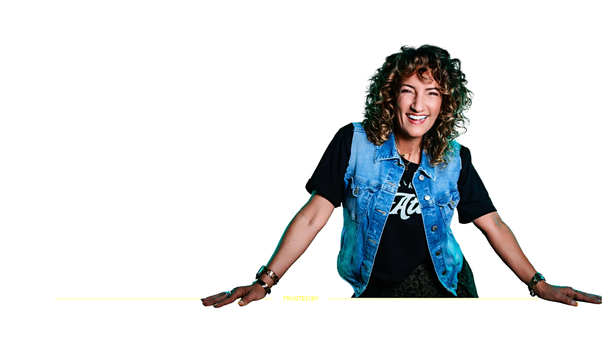 Laya Hoffman smiling, wearing a denim vest.