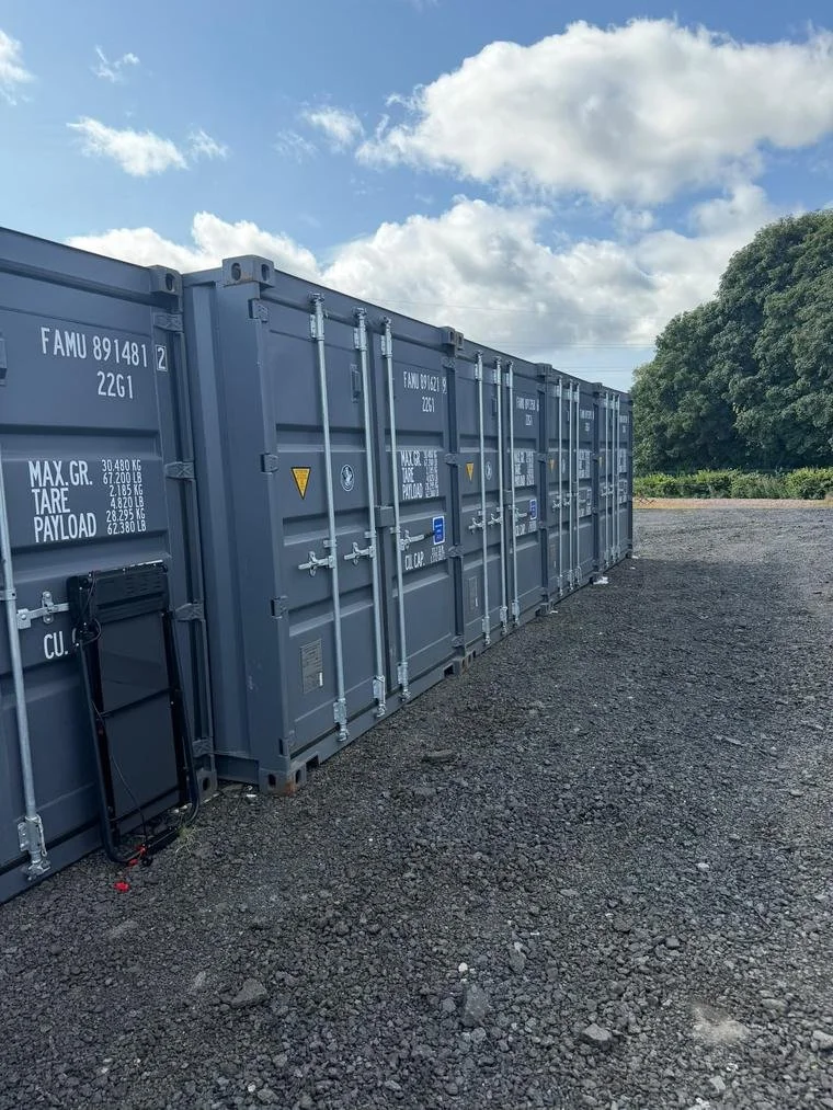Grey 20ft storage containers with side-opening doors on the yard