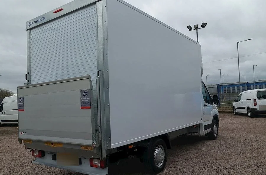 The Luton van with its tail lift folded at the rear