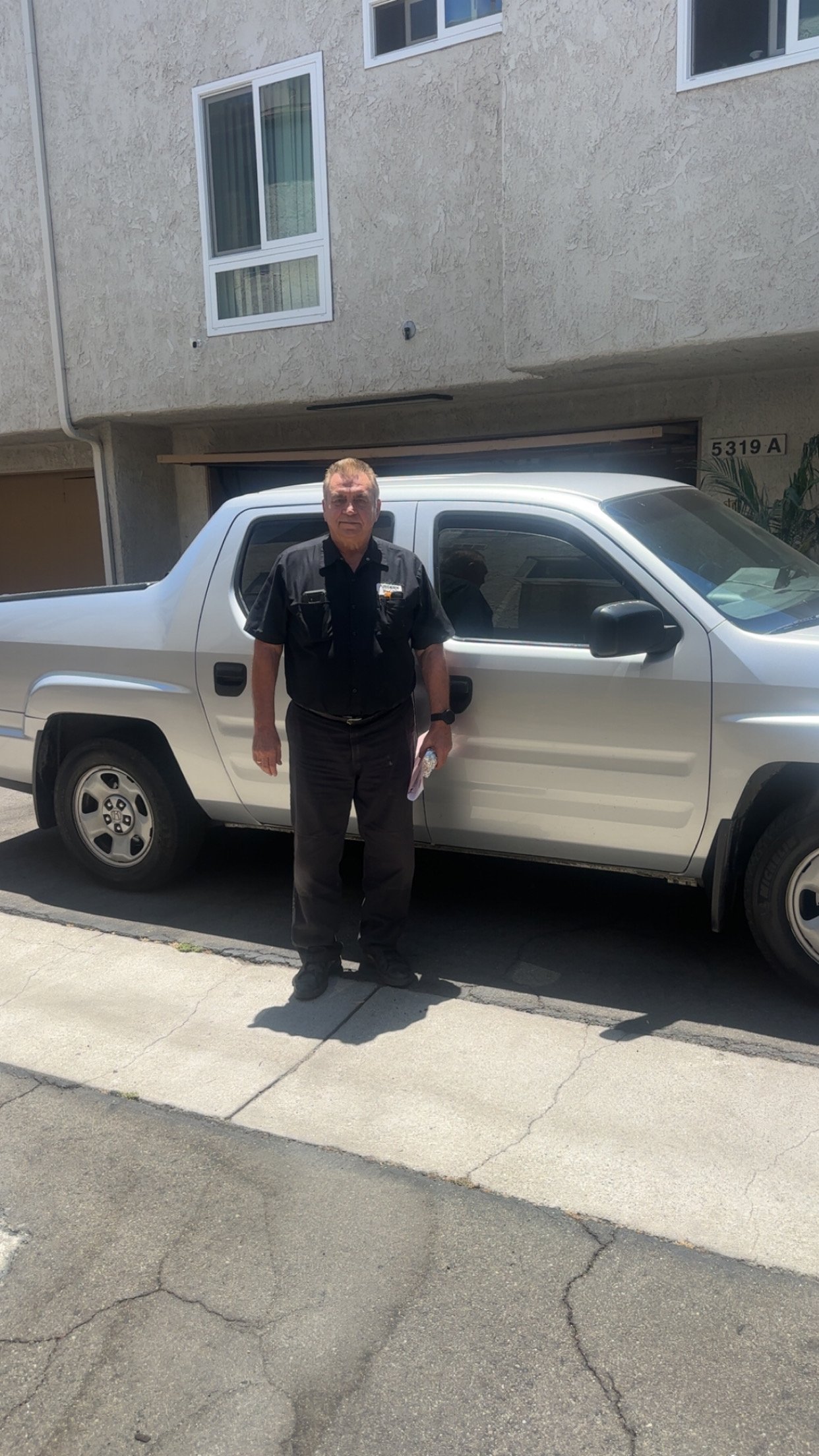 Barry's Appliance Repair technician standing next to a service vehicle