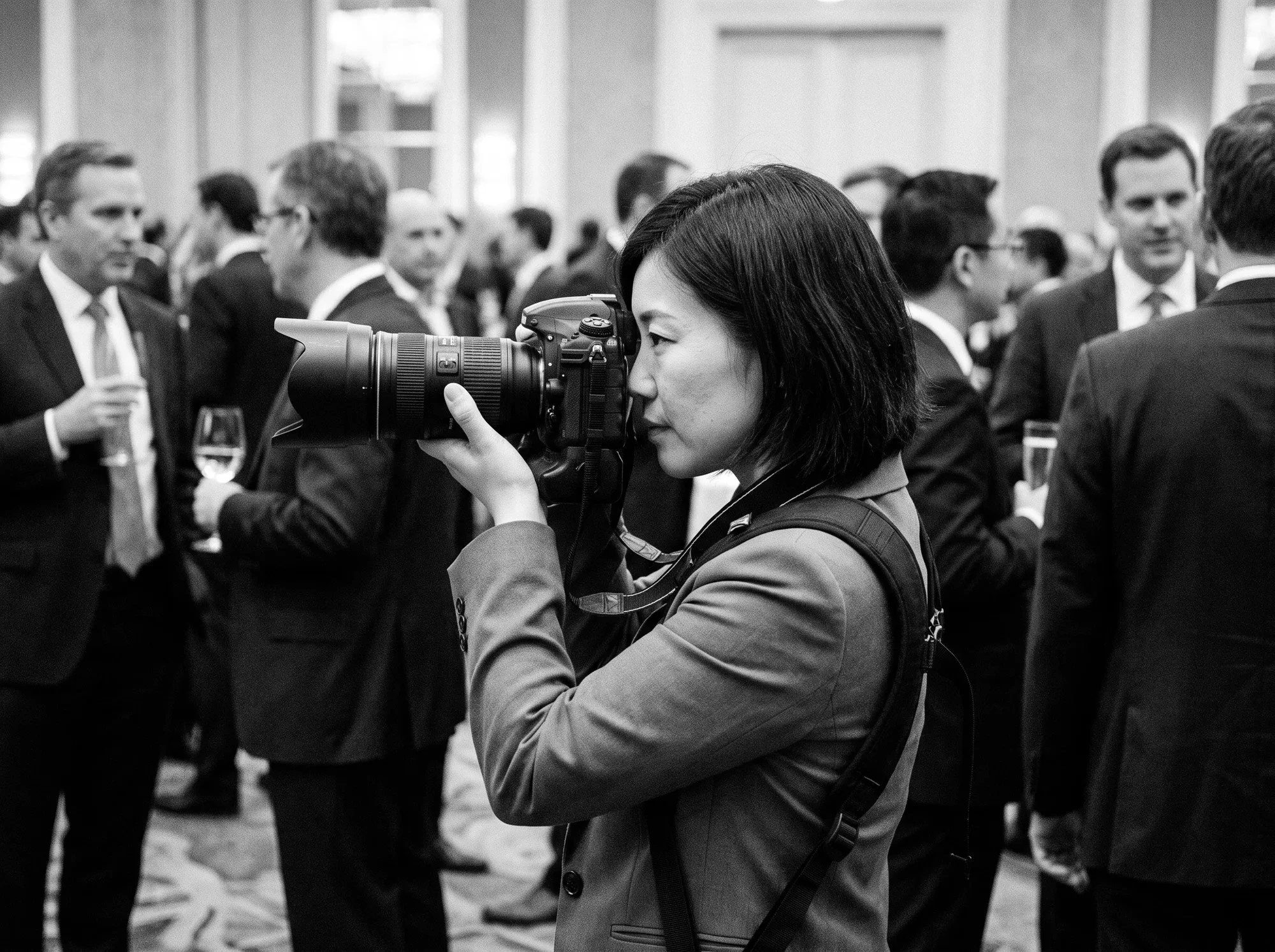 An event photographer concentrating on her next shot