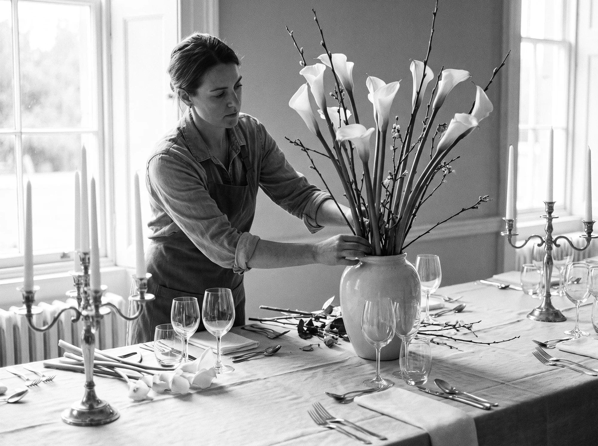 A florist arranging a reception centerpiece