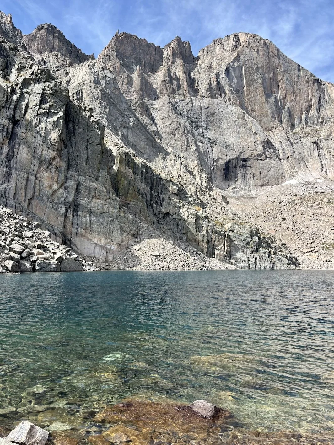 Alpine lake below rocky peaks