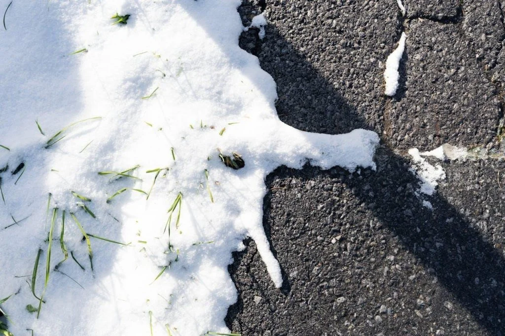 Snow melting in the road