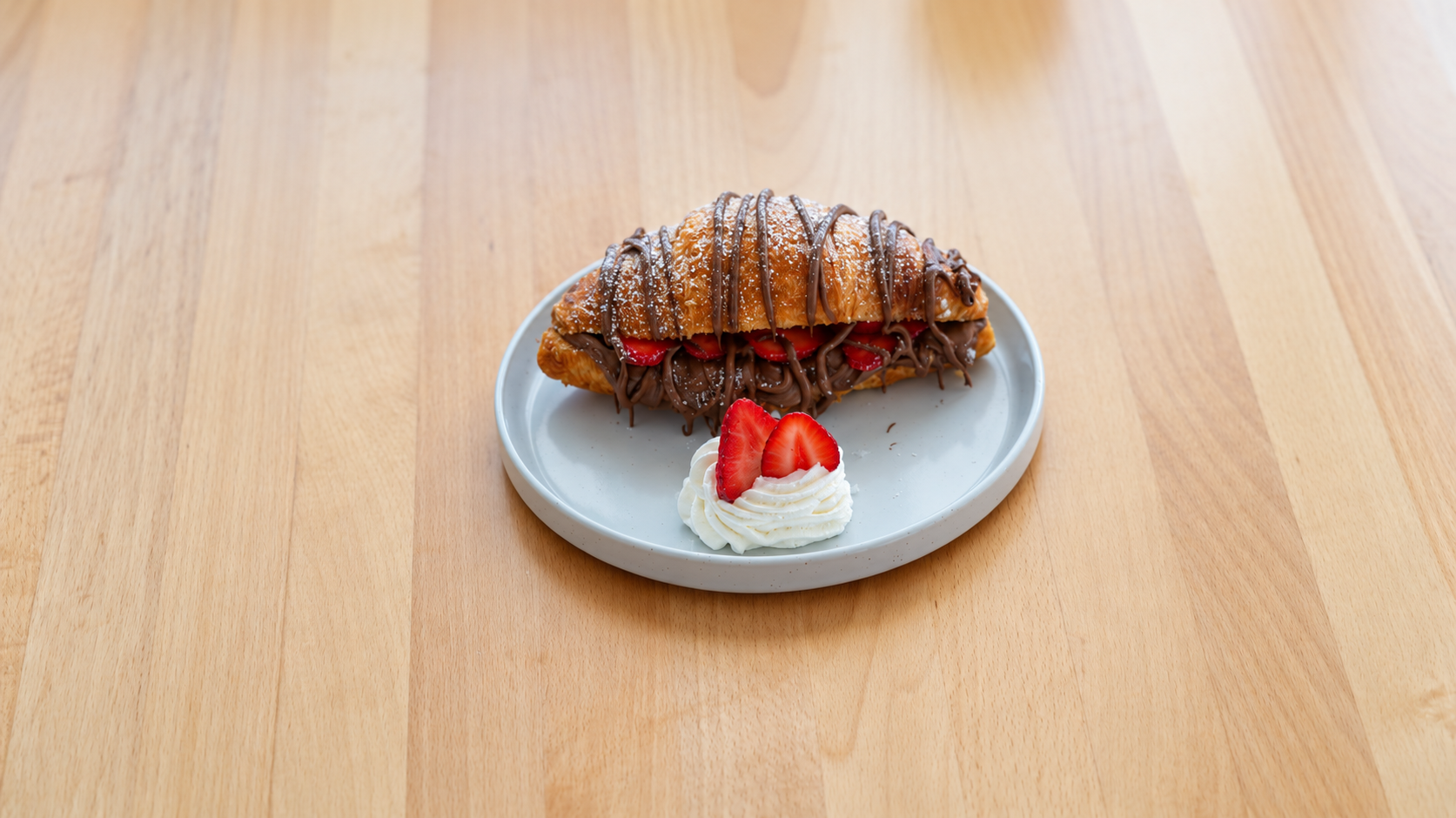Le Brulée Nutella Croissant with chocolate hazelnut filling and fresh strawberries