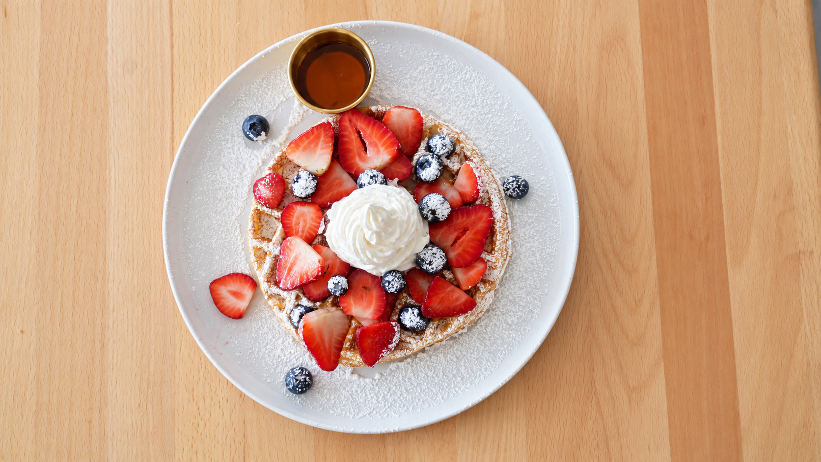 Berry Bliss Waffle topped with strawberries, blueberries, and whipped cream