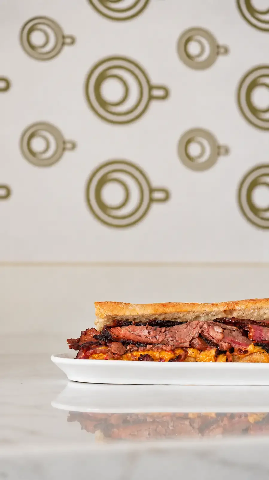 Le Brulée Café brisket baguette served on a plate