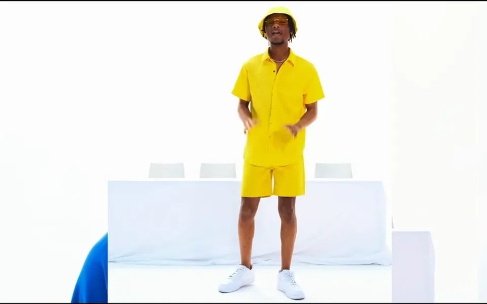 A performer against a bright studio backdrop
