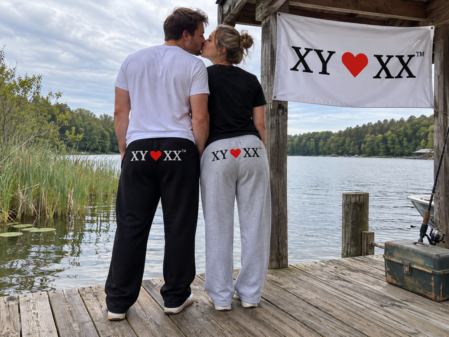 Rear view of a kissing couple wearing black and gray TSF sweatpants with rear logos.