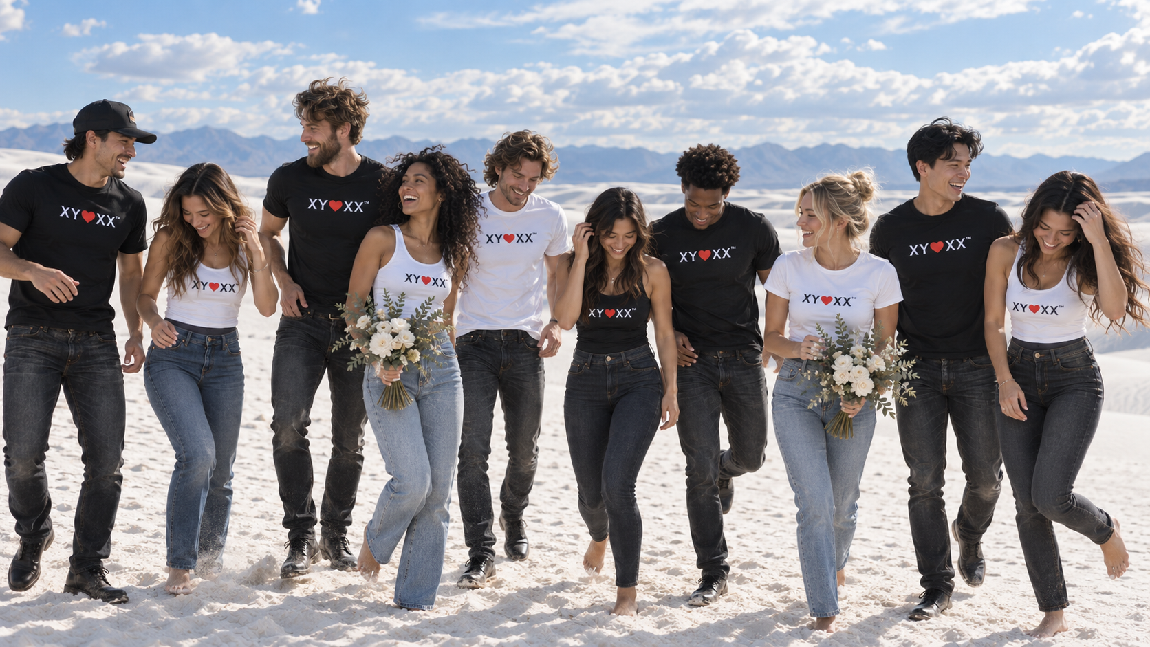 Friends laughing together in black and white signature tops on white desert dunes.