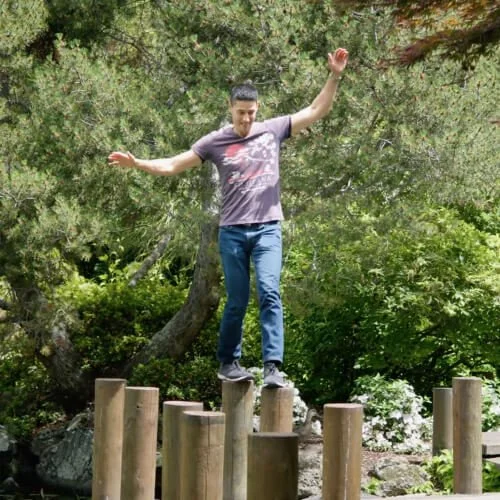 Daniel balancing on logs, with text 'Deep work'