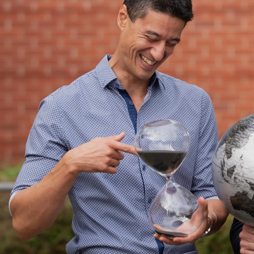 Daniel holding a sand timer, with text 'Keeping pace'