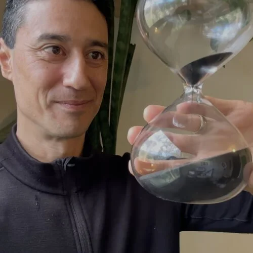 Daniel flips a sand timer, with text 'Keeping pace'