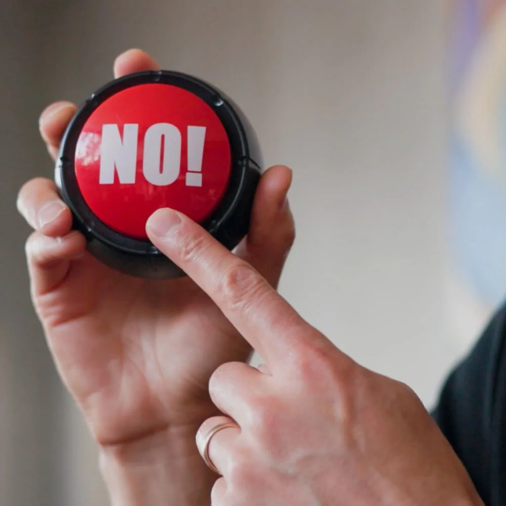Daniel pointing to a red 'no' button, with text 'Saying no'