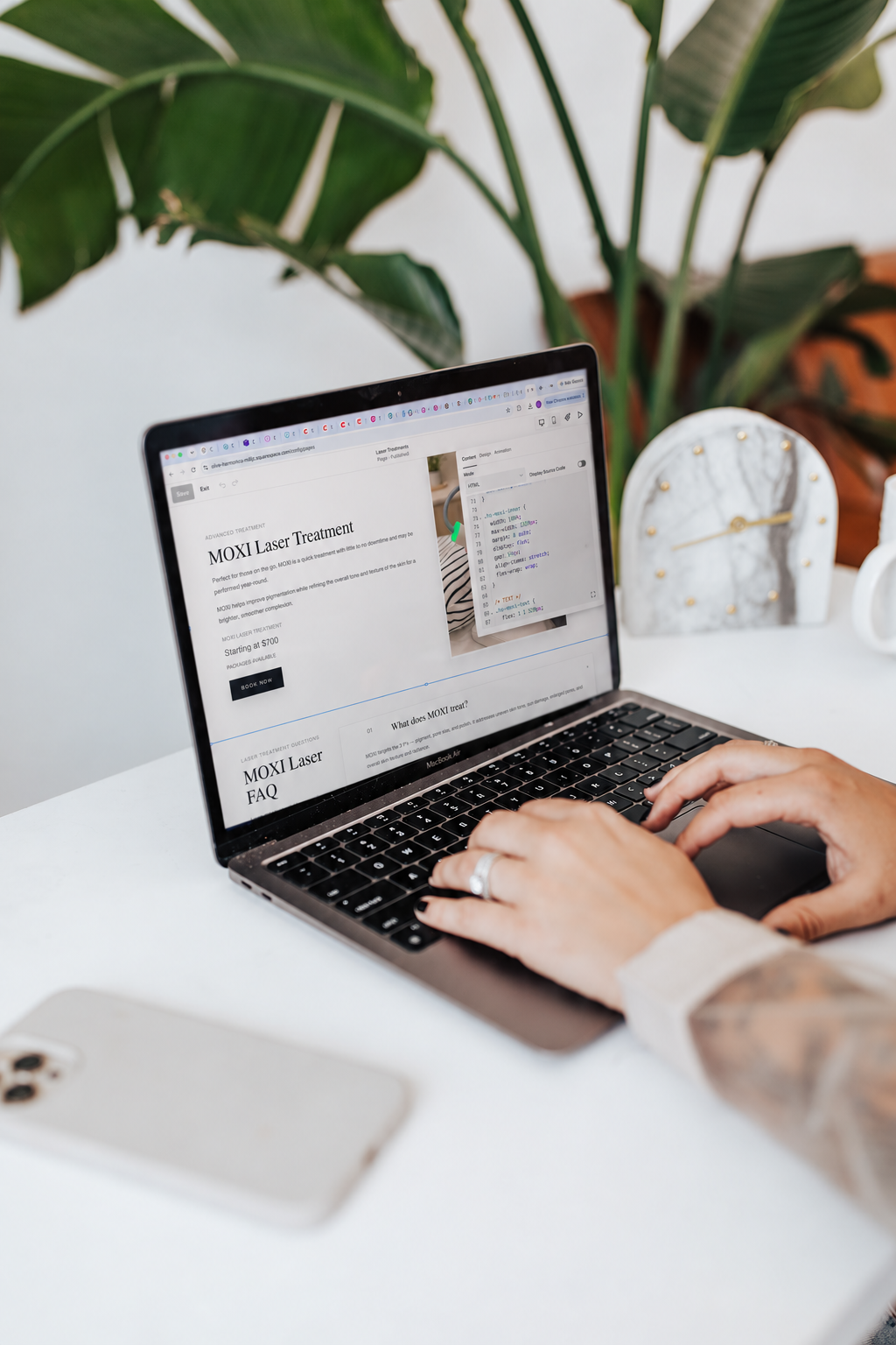 Hands on a laptop editing a Squarespace service page, with custom CSS open beside the layout
