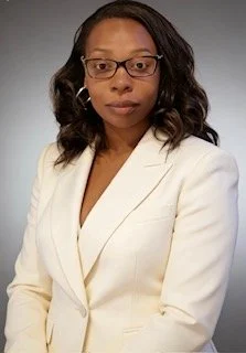 Charlene Hamm in her white suit, Chief Executive Officer
