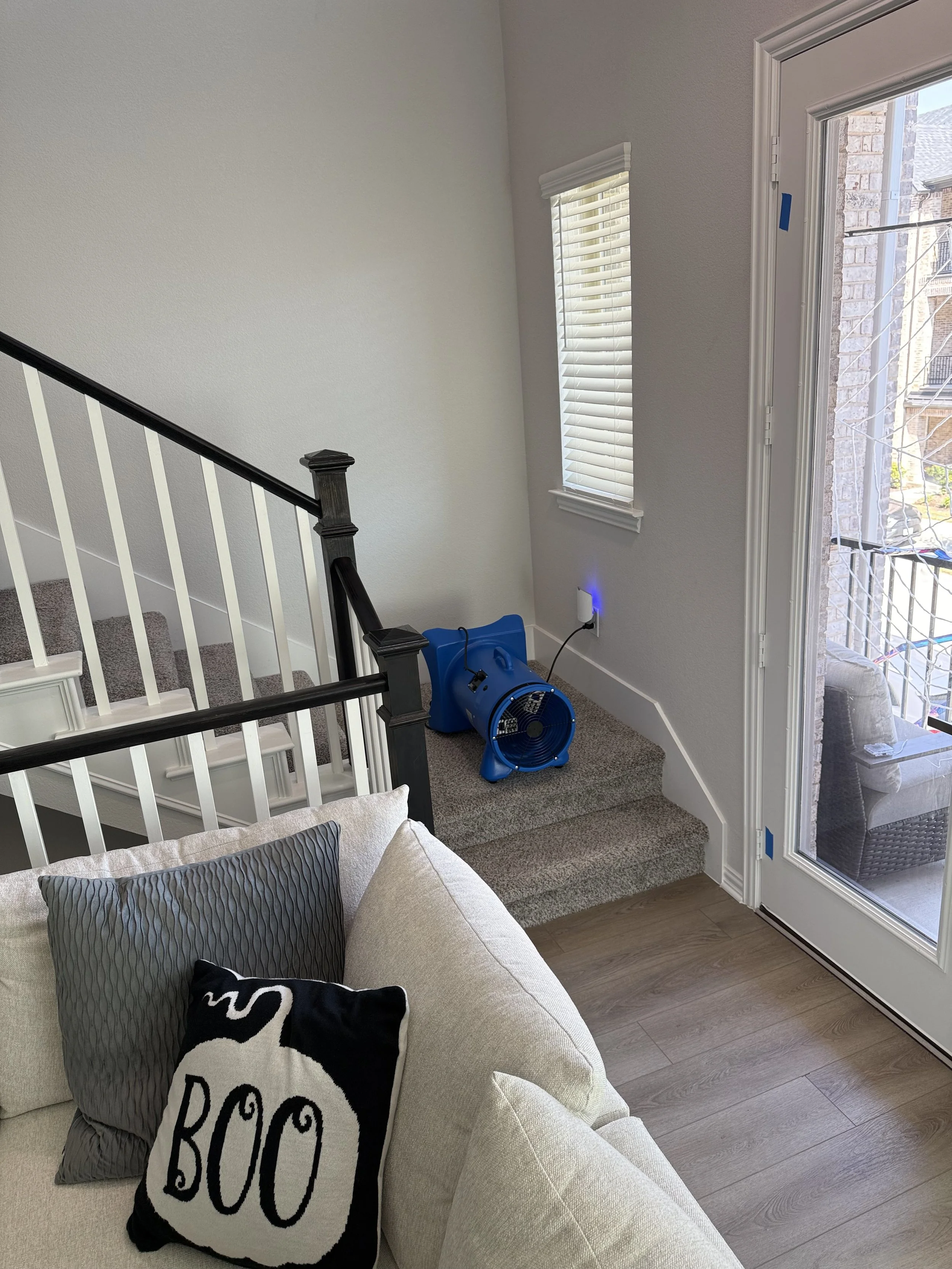 Cross Timbers blue blower-style equipment positioned on a carpeted stair landing