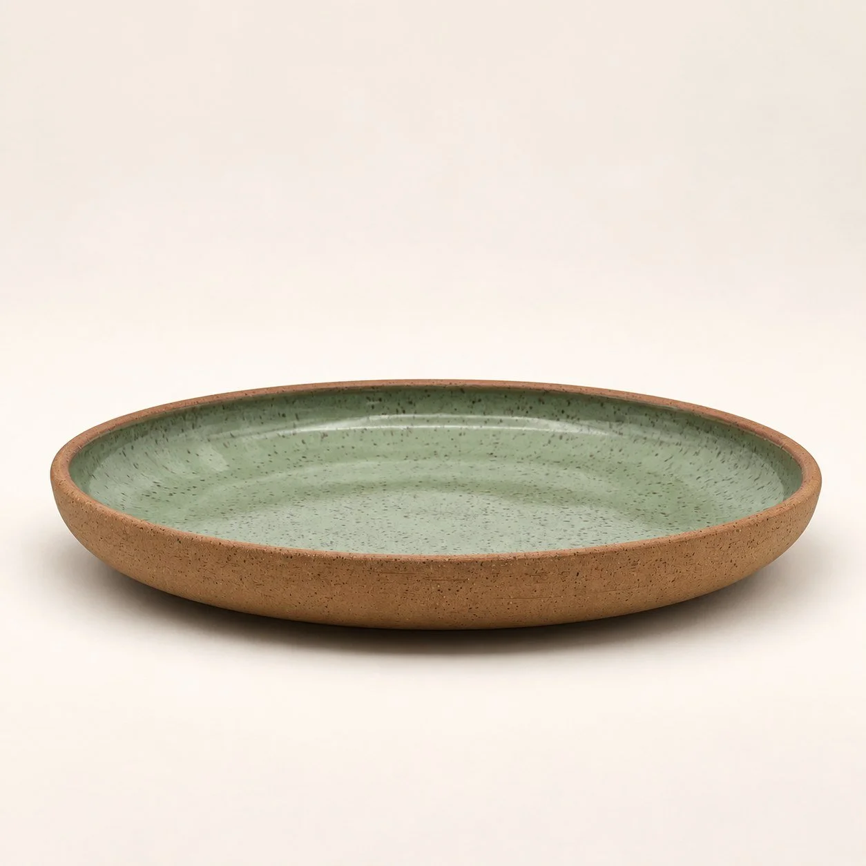 Sage green plate · Gloss glaze, unglazed exterior