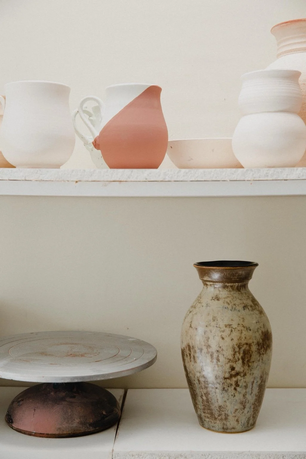 Finished pottery and works in progress on John's studio shelves