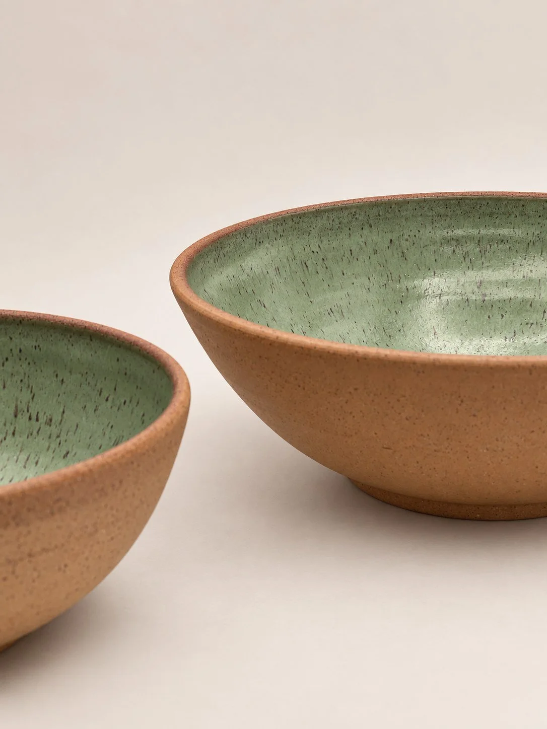 Sage green bowls · Gloss glaze, unglazed exterior