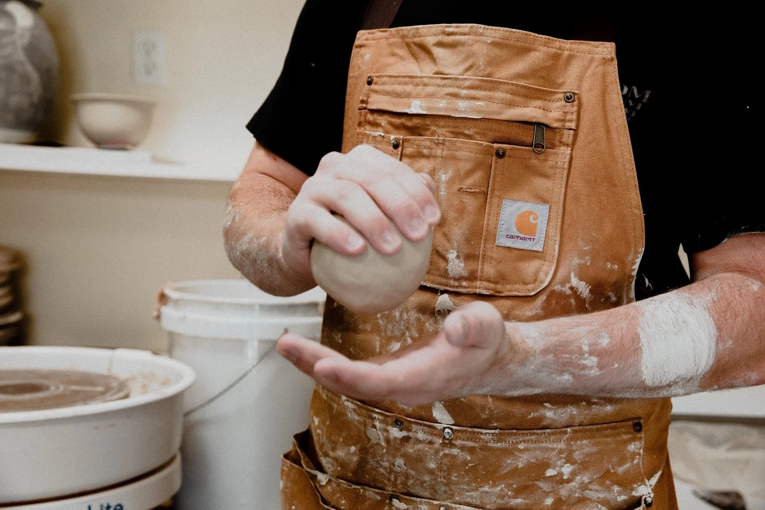 John preparing a ball of clay by hand