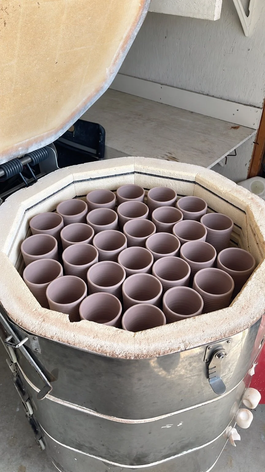 Open Skutt kiln filled with rows of wheel thrown cups