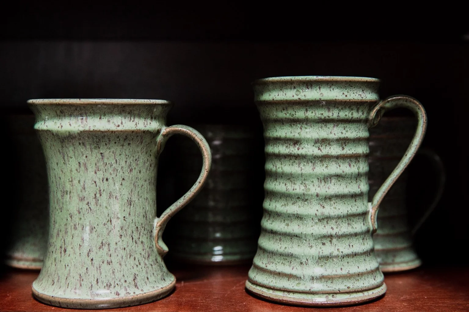Two green glazed handmade mugs