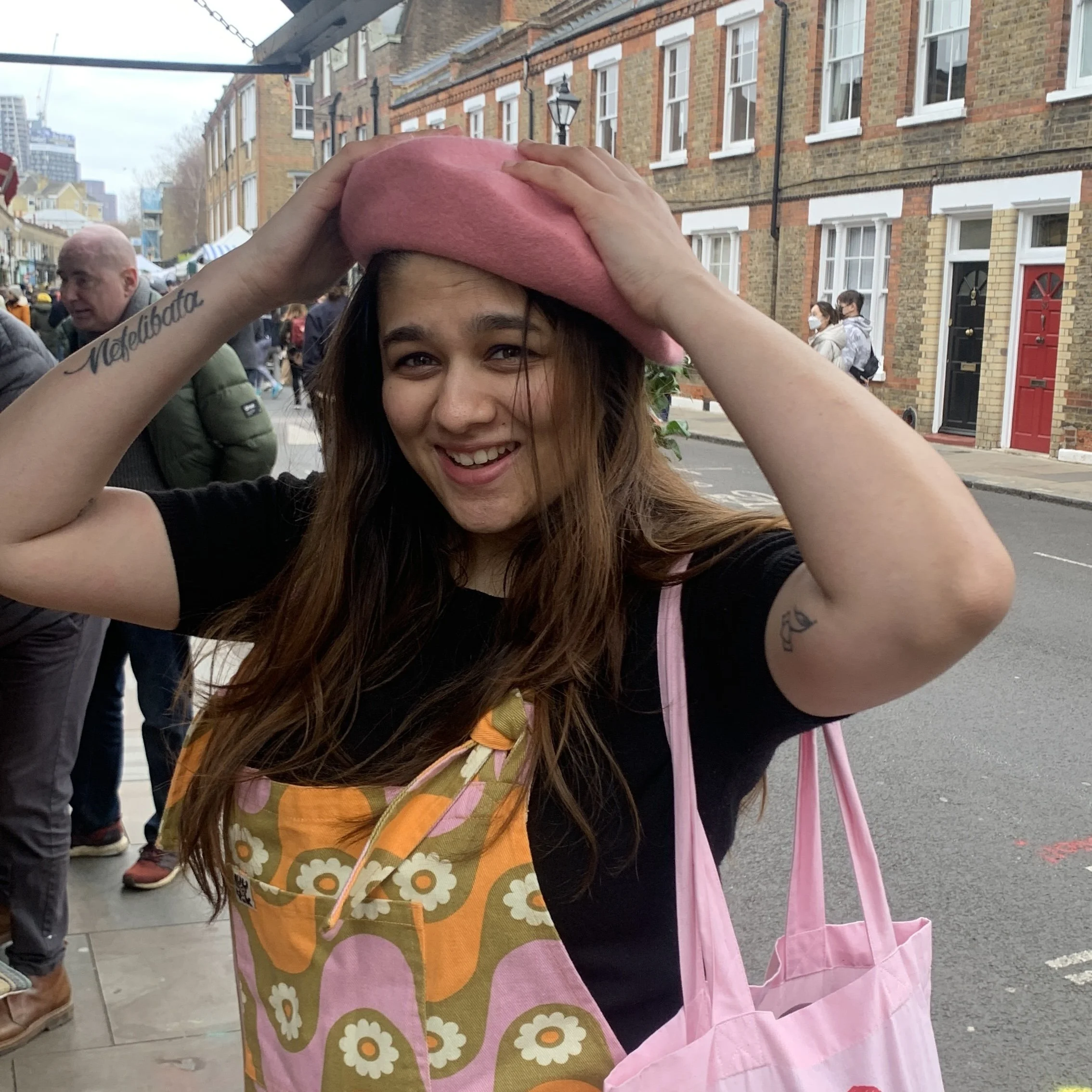 Creator wearing a pink beret on a street