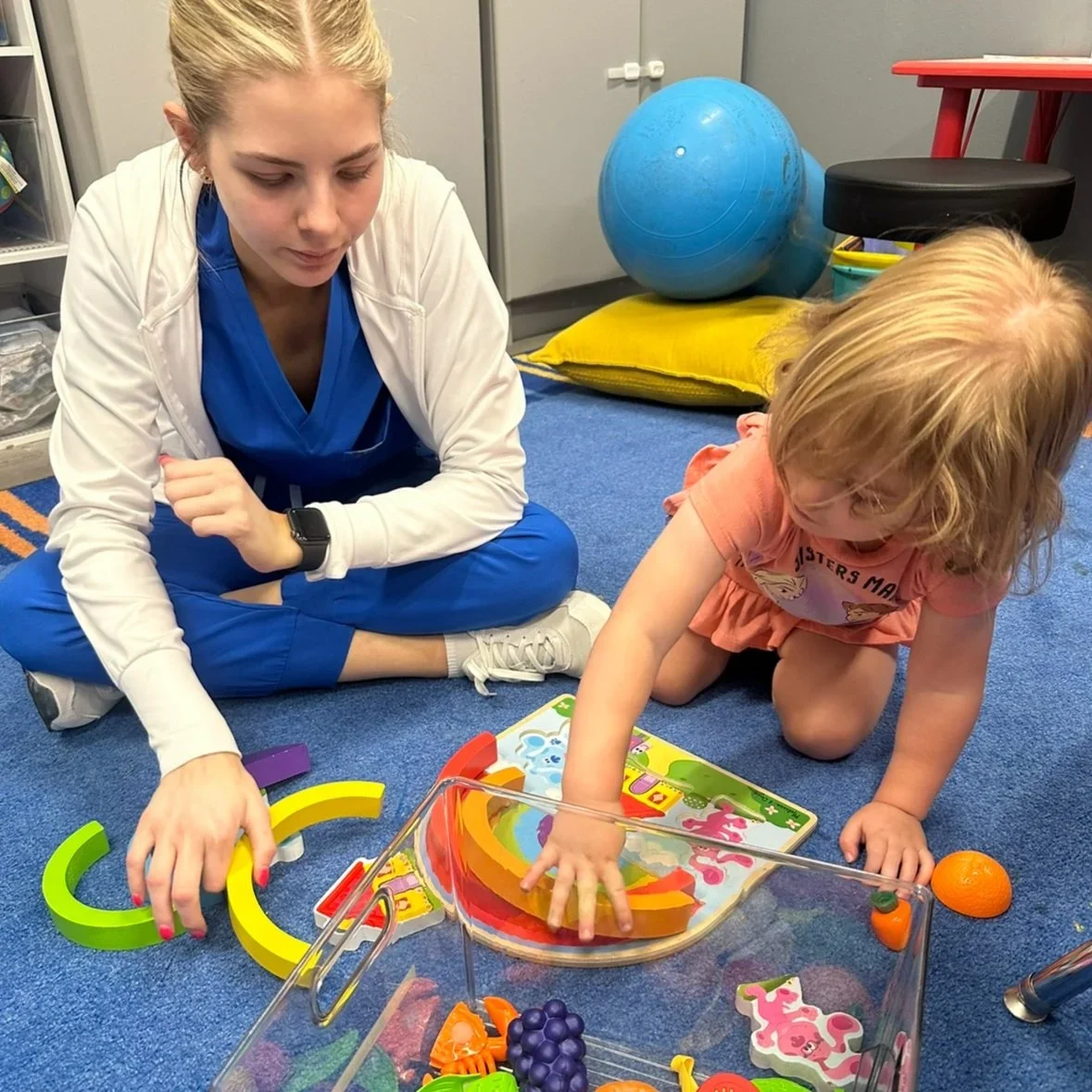 A FUNdamental student working with a child during a session