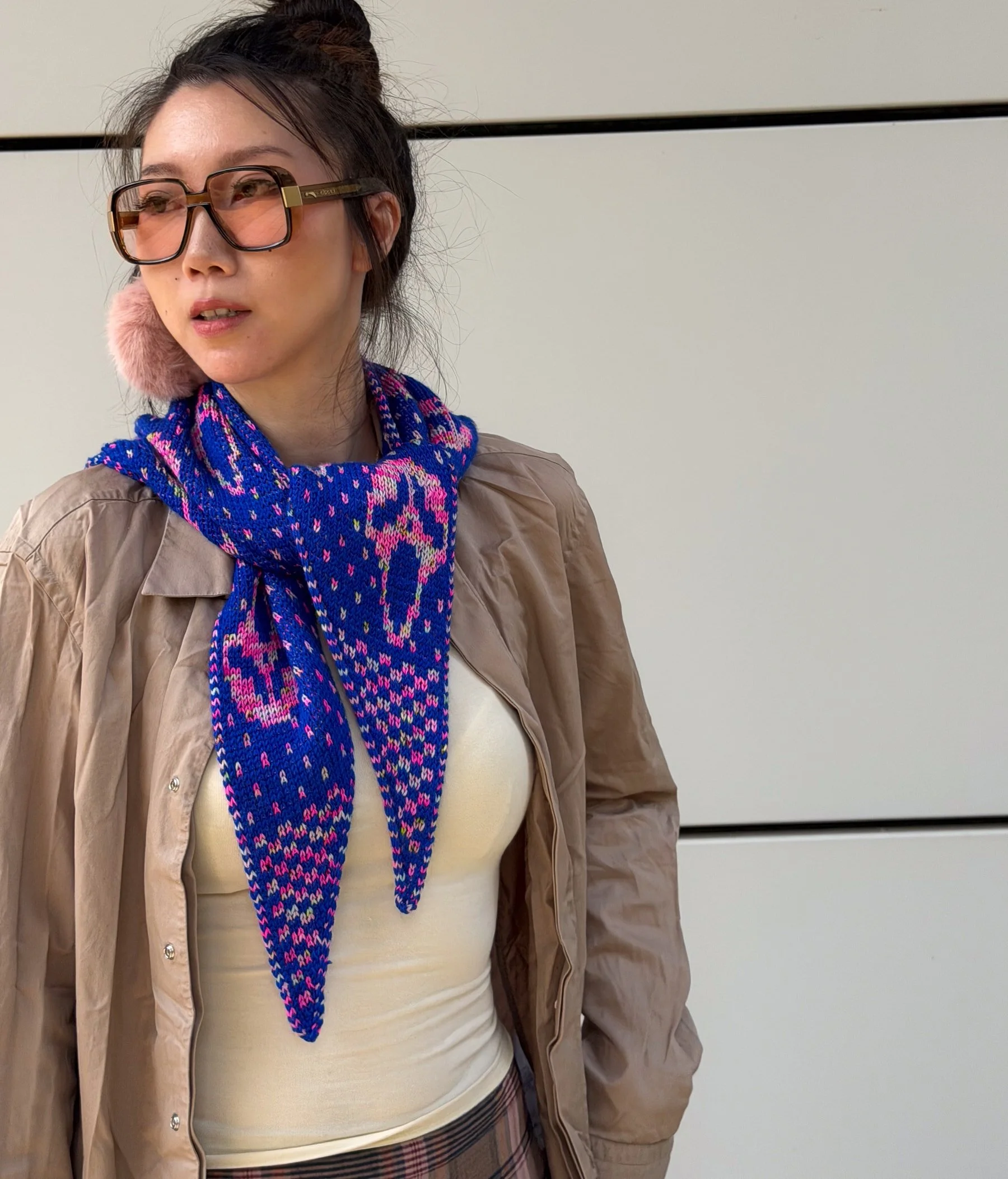 Qing wearing the blue and pink Slasher scarf tied at the neck, with the face motifs visible