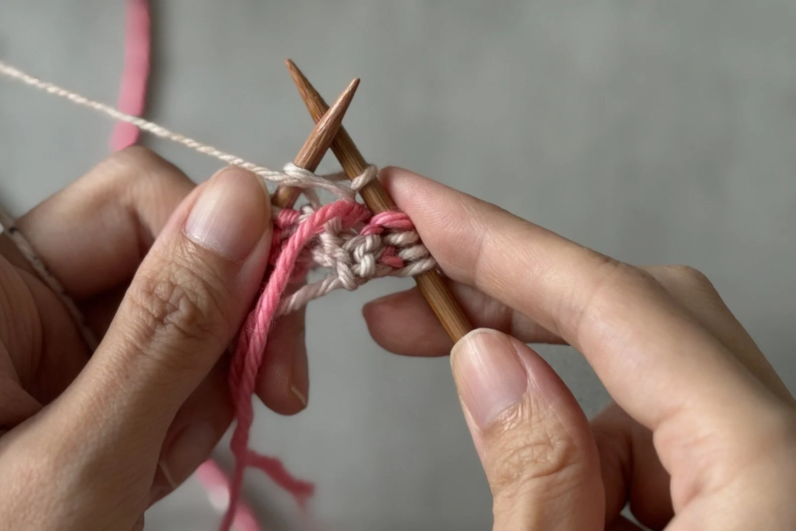 The centre pair being worked on the Side B setup row using the pink and white yarns.
