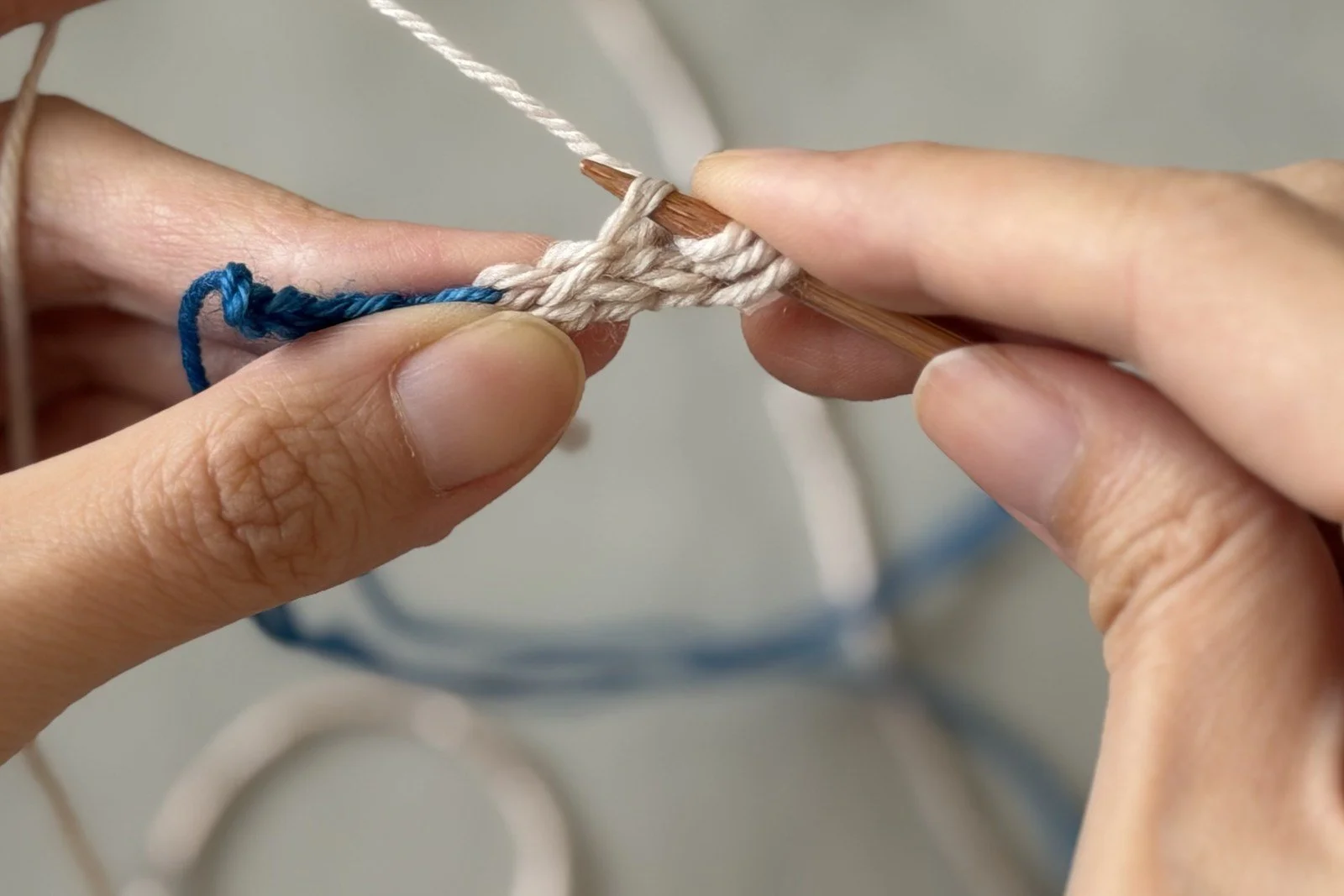 The white cord rotated sideways as the needle picks up a side stitch with CC.