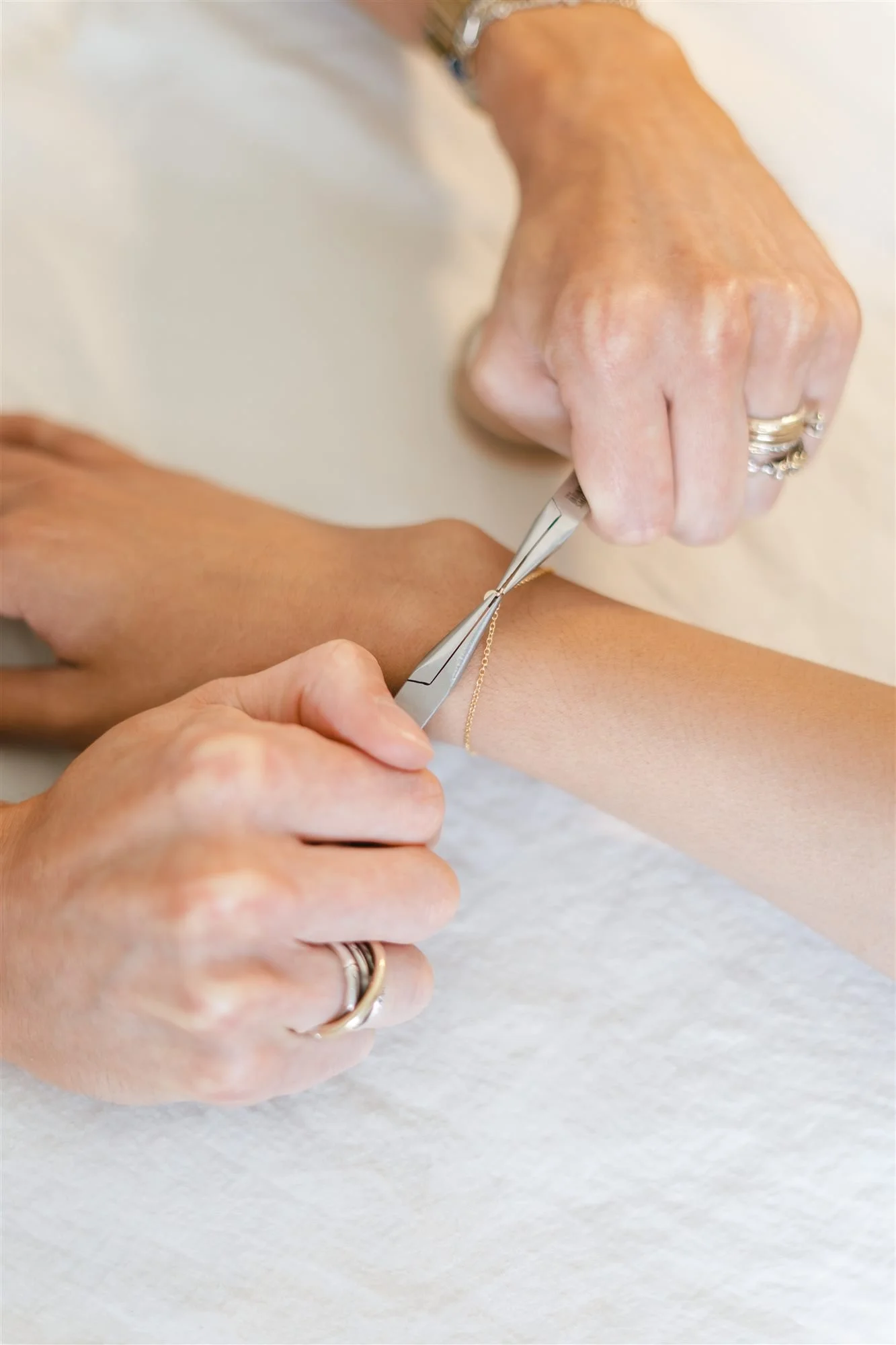 Guest receiving permanent jewelry